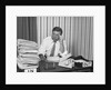 Concerned businessman staring large pile paperwork in in-box by Anonymous