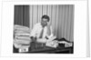 Concerned businessman staring large pile paperwork in in-box by Anonymous