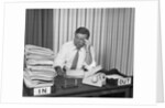 Concerned businessman staring large pile paperwork in in-box by Anonymous