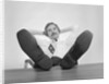 Businessman sitting feet up on desk by Anonymous