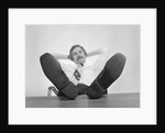 Businessman sitting feet up on desk by Anonymous