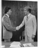 Two businessmen shaking hands handshake by Anonymous