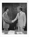 Two businessmen shaking hands handshake by Anonymous