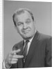 Portrait man pointing wearing suit tie smiling by Anonymous