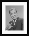 Portrait man pointing wearing suit tie smiling by Anonymous
