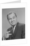 Portrait man pointing wearing suit tie smiling by Anonymous