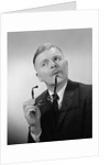 Serious thinking thoughtful older man holding eyeglasses to chin by Anonymous