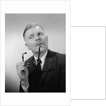 Serious thinking thoughtful older man holding eyeglasses to chin by Anonymous