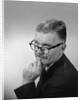 Middle aged man wearing eyeglasses low on nose quizzical facial expression by Anonymous