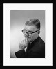 Middle aged man wearing eyeglasses low on nose quizzical facial expression by Anonymous