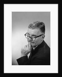 Middle aged man wearing eyeglasses low on nose quizzical facial expression by Anonymous