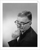 Middle aged man wearing eyeglasses low on nose quizzical facial expression by Anonymous