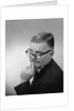 Middle aged man wearing eyeglasses low on nose quizzical facial expression by Anonymous