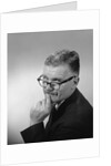 Middle aged man wearing eyeglasses low on nose quizzical facial expression by Anonymous
