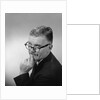 Middle aged man wearing eyeglasses low on nose quizzical facial expression by Anonymous