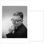 Middle aged man wearing eyeglasses low on nose quizzical facial expression by Anonymous