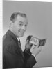 Man smiling holding wallet showing photo of family by Anonymous