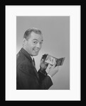 Man smiling holding wallet showing photo of family by Anonymous
