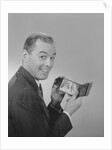 Man smiling holding wallet showing photo of family by Anonymous