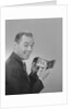 Man smiling holding wallet showing photo of family by Anonymous