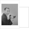 Man smiling holding wallet showing photo of family by Anonymous