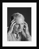 Older man with hands holding head temples by Anonymous
