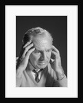 Older man with hands holding head temples by Anonymous