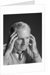 Older man with hands holding head temples by Anonymous