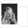 Older man with hands holding head temples by Anonymous