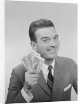 Smiling man holding a fistful of money fake bills by Anonymous