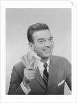 Smiling man holding a fistful of money fake bills by Anonymous