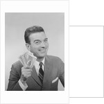 Smiling man holding a fistful of money fake bills by Anonymous