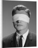 Young man wearing blindfold by Anonymous