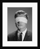 Young man wearing blindfold by Anonymous