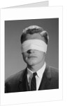 Young man wearing blindfold by Anonymous