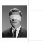 Young man wearing blindfold by Anonymous
