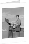 Smiling woman dropping letters in postal mail box by Anonymous
