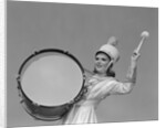 Smiling young woman band uniform carrying playing big drum by Anonymous