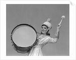 Smiling young woman band uniform carrying playing big drum by Anonymous