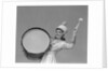 Smiling young woman band uniform carrying playing big drum by Anonymous