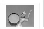 Smiling young woman band uniform carrying playing big drum by Anonymous