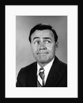 Businessman making funny face looking to the side by Anonymous