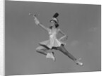Woman majorette holding baton wearing short skirt uniform jumping into the air by Anonymous