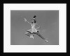 Woman majorette holding baton wearing short skirt uniform jumping into the air by Anonymous