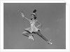 Woman majorette holding baton wearing short skirt uniform jumping into the air by Anonymous