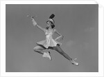 Woman majorette holding baton wearing short skirt uniform jumping into the air by Anonymous