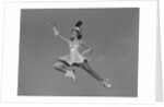 Woman majorette holding baton wearing short skirt uniform jumping into the air by Anonymous