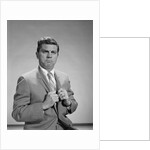 Portrait middle aged man stern serious expression hands gripping his lapels by Anonymous