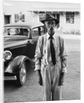 Portrait of old man wearing hat glasses tie & suspenders car in background by Anonymous
