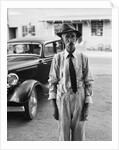 Portrait of old man wearing hat glasses tie & suspenders car in background by Anonymous